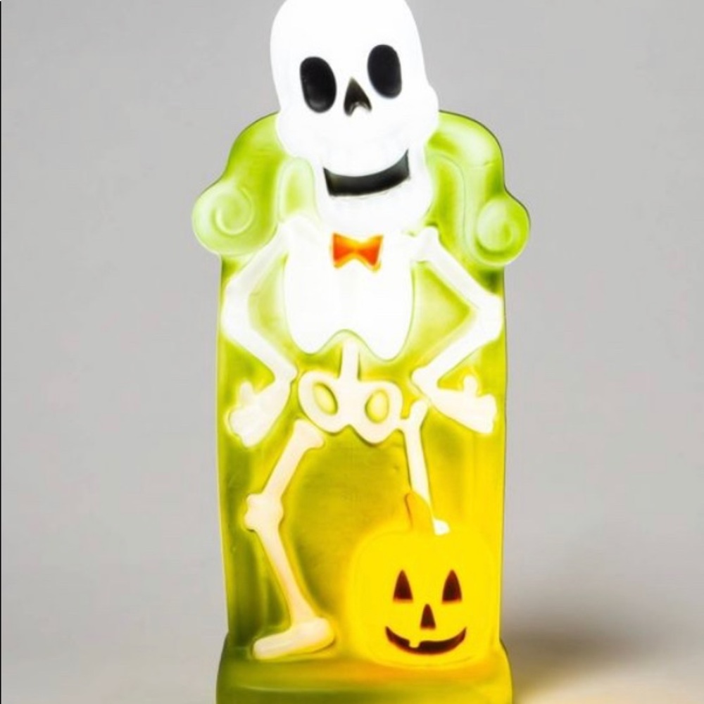 Skeleton laughing while standing over a pumpkin - Picture 2 of 2